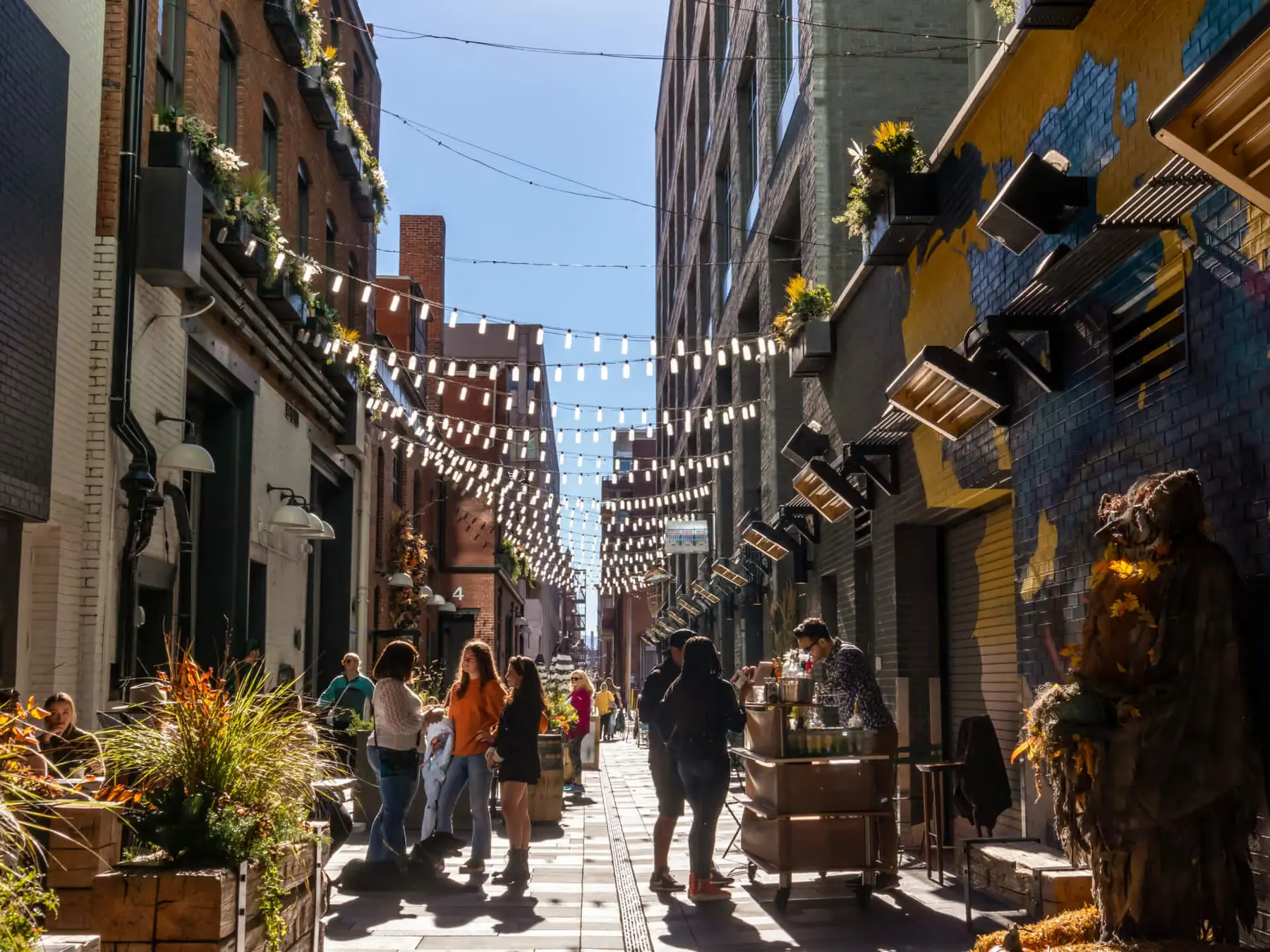 A street of restaurants and string lights in downtown Denver