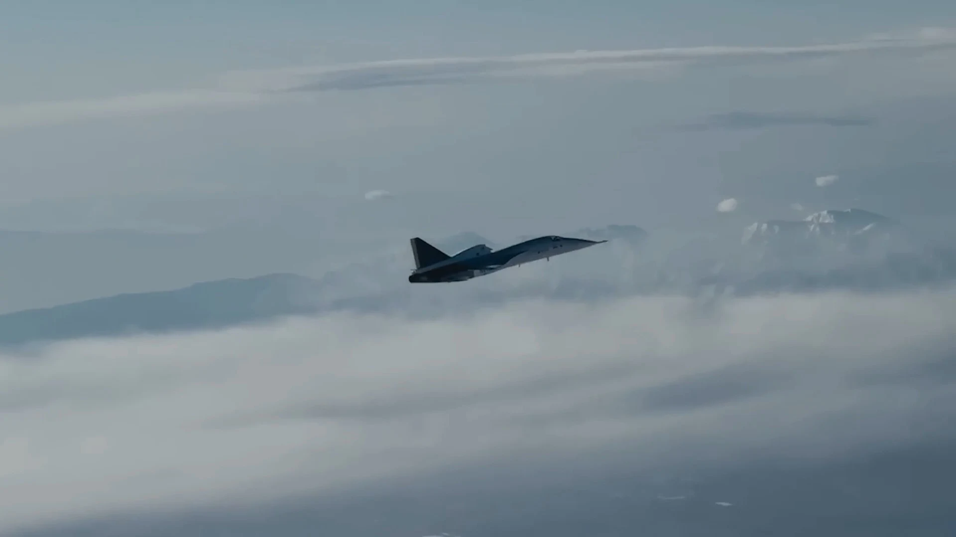 XB-1 in silhouette, flying above a layer of cloud